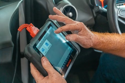 Technician reviewing live diagnostic data on a handheld scan tool