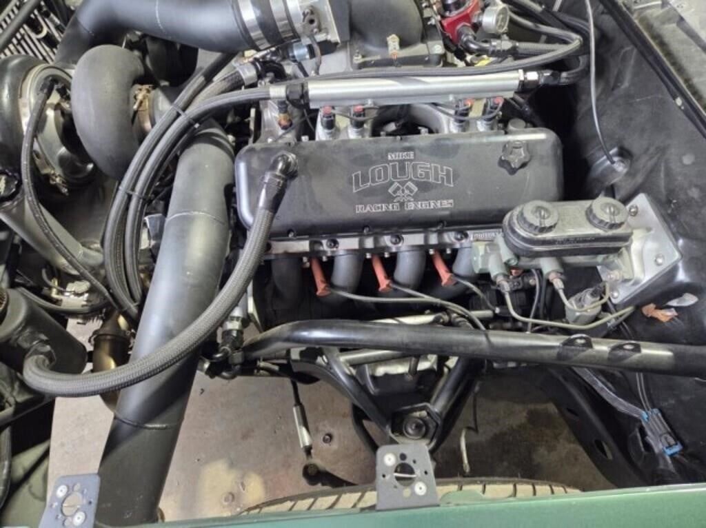 Engine bay of a green Chevrolet Malibu performance build